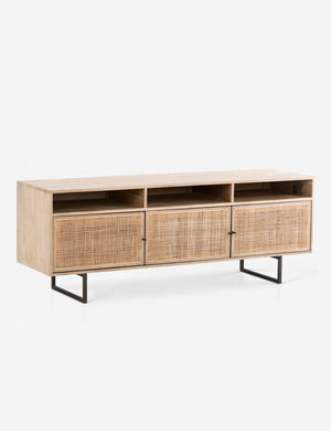 Angled view of the Hannah natural mango wood media console with cane doors.
