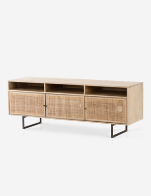 Angled view of the Hannah natural mango wood media console with cane doors.