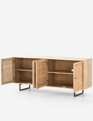 All four cane doors open on the Hannah natural mango wood sideboard with cane doors and an iron base, revealing the inner shelving.