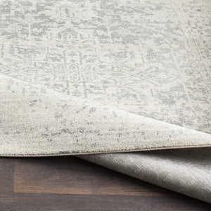 Corner shot of the Prisha bohemian style distressed stone gray rug