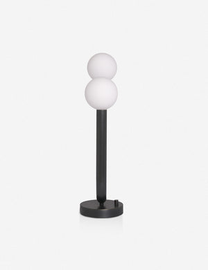 Side view of the Happy black, oil-rubbed bronze table lamp by Regina Andrew with a dual-metal tube silhouette with contrasting matte white bumbs