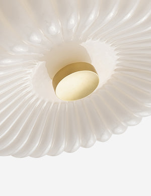 Close-up view of the bottom of the Harissa white ribbed flush mount light with brass detail