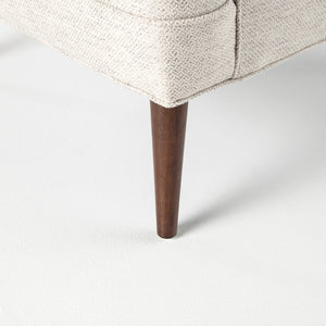 The tapered dark wooden legs on the Ilona accent chair