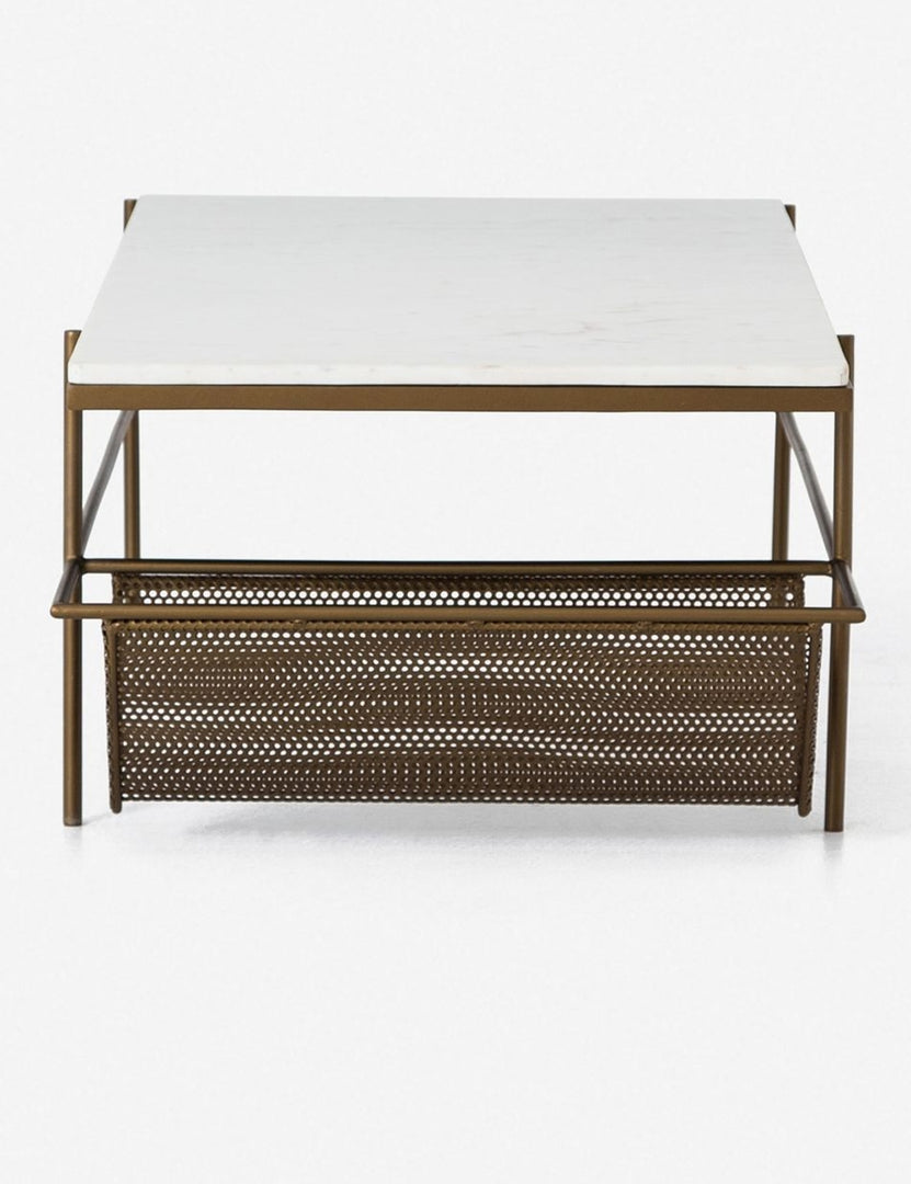 | Side view of the left side of the Thina rectangular marble coffee table with gold hardware, featuring the mesh magazine shelf