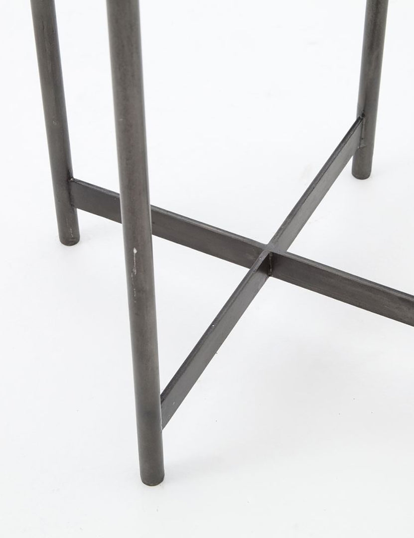 | Close-up of the base of the Gianea side table with geometric white marble top and black metal frame