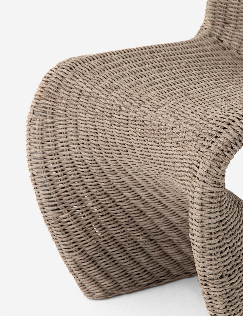 #color::natural | Close-up of the scooped base on the Manila wicker weave beige indoor and outdoor dining chair