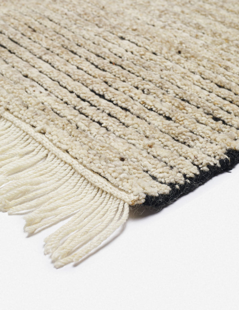 #size::6--x-9- #size::8--x-10- #size::9--x-12- #color::black-and-natural #size::10--x-14- | The fringe on the corner of the Kenzi black and natural rug