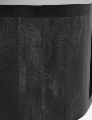 Detailed shot of the black wood paneling on the Luna black wood oval coffee table.