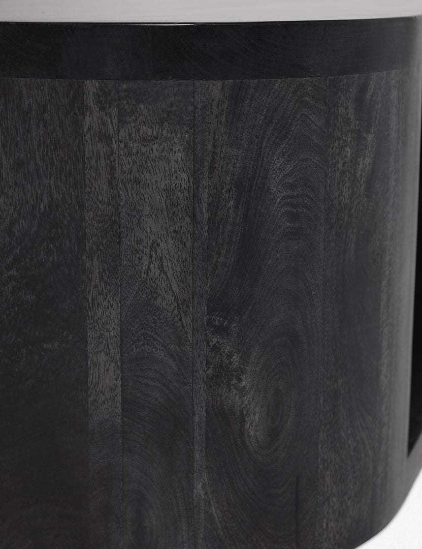 #color::black | Detailed shot of the black wood paneling on the Luna black wood oval coffee table.