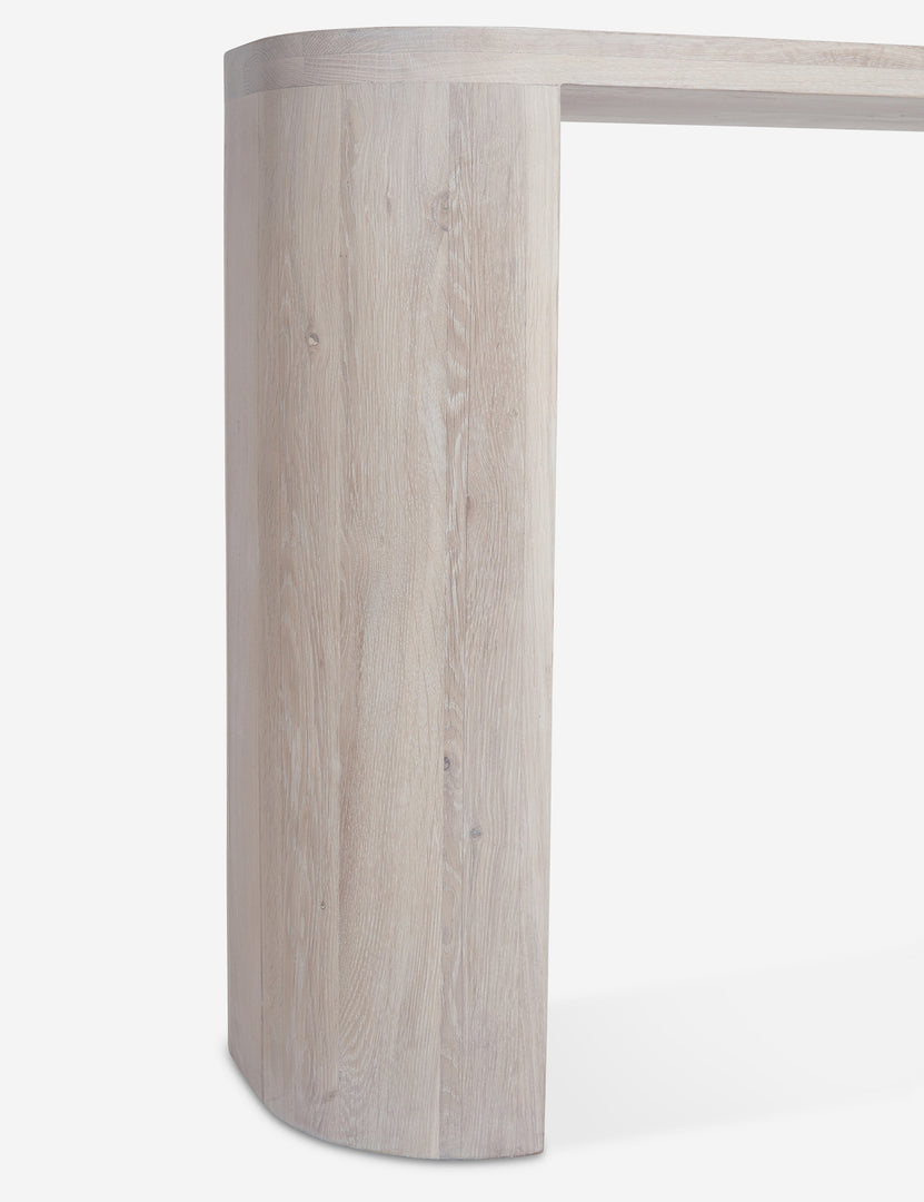 #color::washed-oak | Close-up of the leg of the Luna white-washed oak oval console table.
