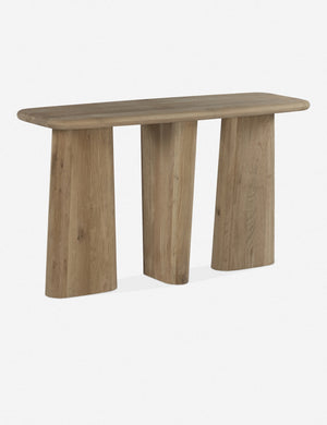 Angled view of the Nera natural wood sculptural console table