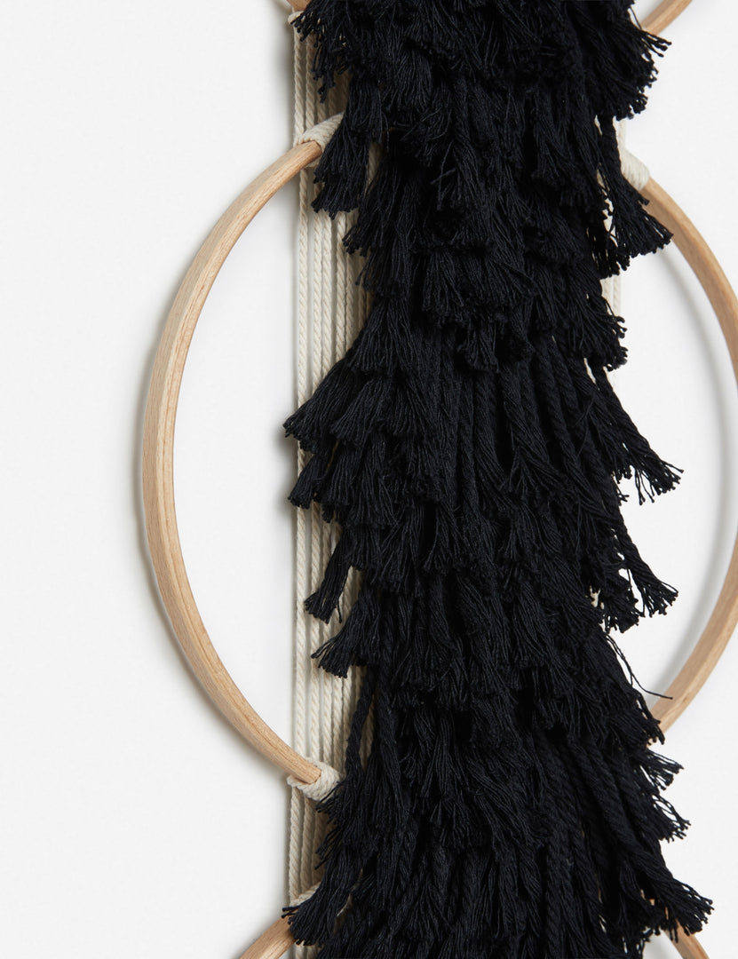#color::black | Close-up of the tasseled material on the Studio Nom Lwazi black woven Wall Hanging by nom