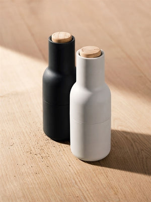 Angled view of the black and white salt and pepper bottle grinders