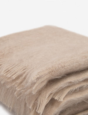 Close-up of the Aimee mohair blush wool throw blanket with fringe ends