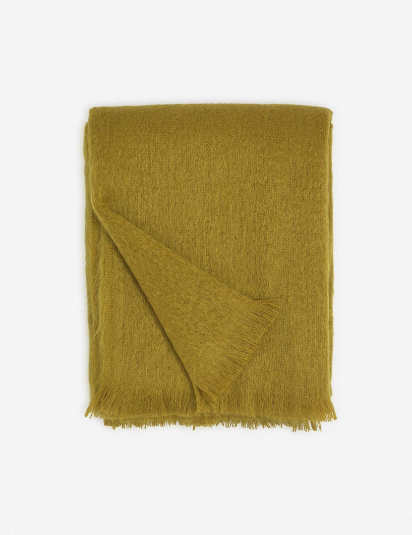#color::mustard | Aimee mohair mustard yellow wool throw blanket with fringe ends with the corner folded in