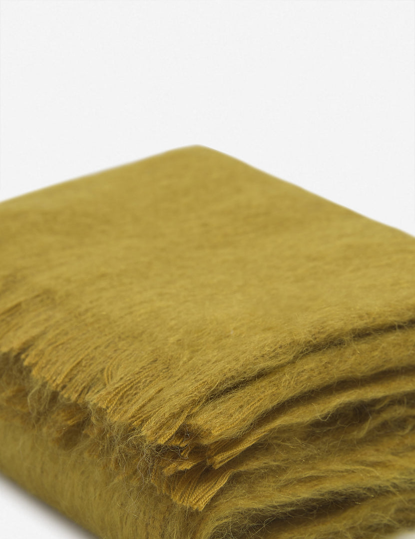 #color::mustard | Close-up of the Aimee mohair mustard yellow wool throw blanket with fringe ends