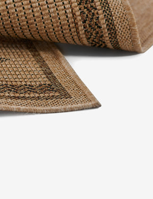 Close-up of the flatweave fabric on the Ember brown patterned indoor and outdoor rug