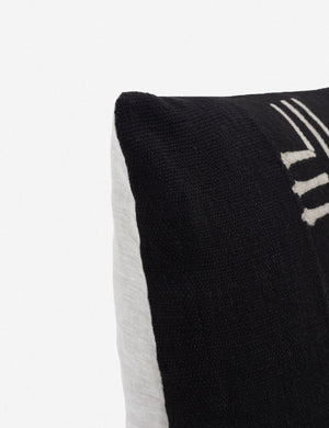 Close-up of the corner of the Nico black handmade mudcloth throw pillow with an alternating x-motif pattern