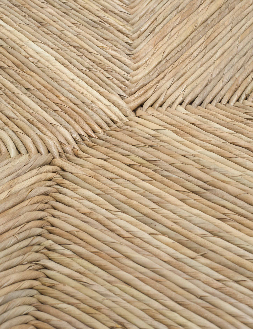 | Detailed shot of the woven rattan material on the Nolani arm chair