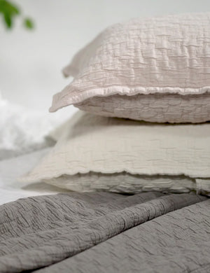 The Ojai Cotton Matelasse Euro Sham by Pom Pom at Home in all its colors are stacked atop each other
