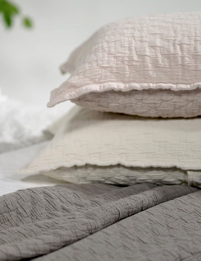 #color::blush #color::greige #size::euro-sham #size::standard #size::king | The Ojai greige and light pink Cotton Matelassé Shams with a diamond woven pattern by Pom Pom at Home lay stacked atop each other