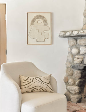 Canyon Olive Green Lumbar Pillow sits on an ivory accent chair next to a stone fireplace
