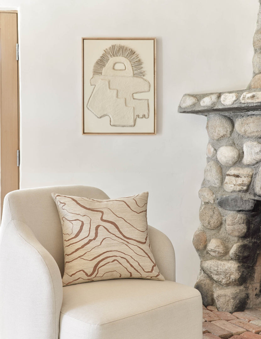 #color::terracotta #style::square | Canyon Terracotta Square Pillow sits on an ivory accent chair next to a stone fireplace
