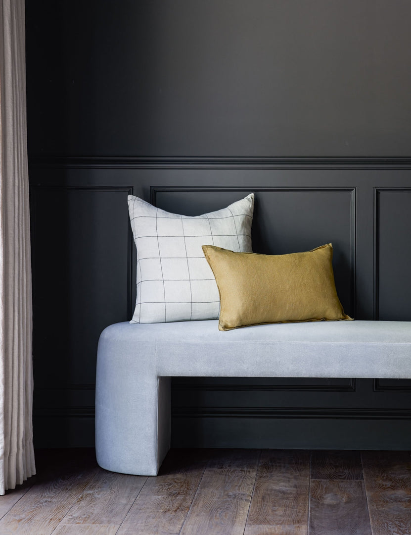 #color::black #size::20--x-20- | The lucian white and black square pillow sits with a yellow pillow on a light blue velvet bench against a black wall