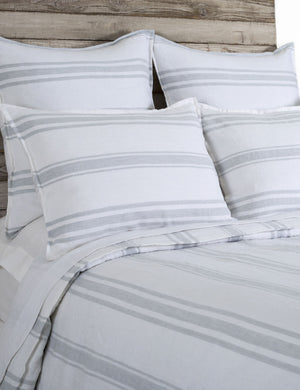 Close up of the Jackson Linen white and ocean striped Duvet by Pom Pom at Home