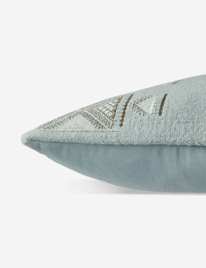 Side view of the Ciecil sky blue throw pillow with an arabesque pattern and a woven cotton front
