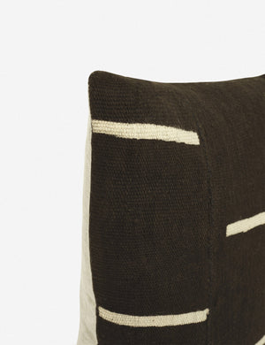 Close-up of the corner of the Rainey mudcloth black and white pillow with a hidden zipper and gray linen back