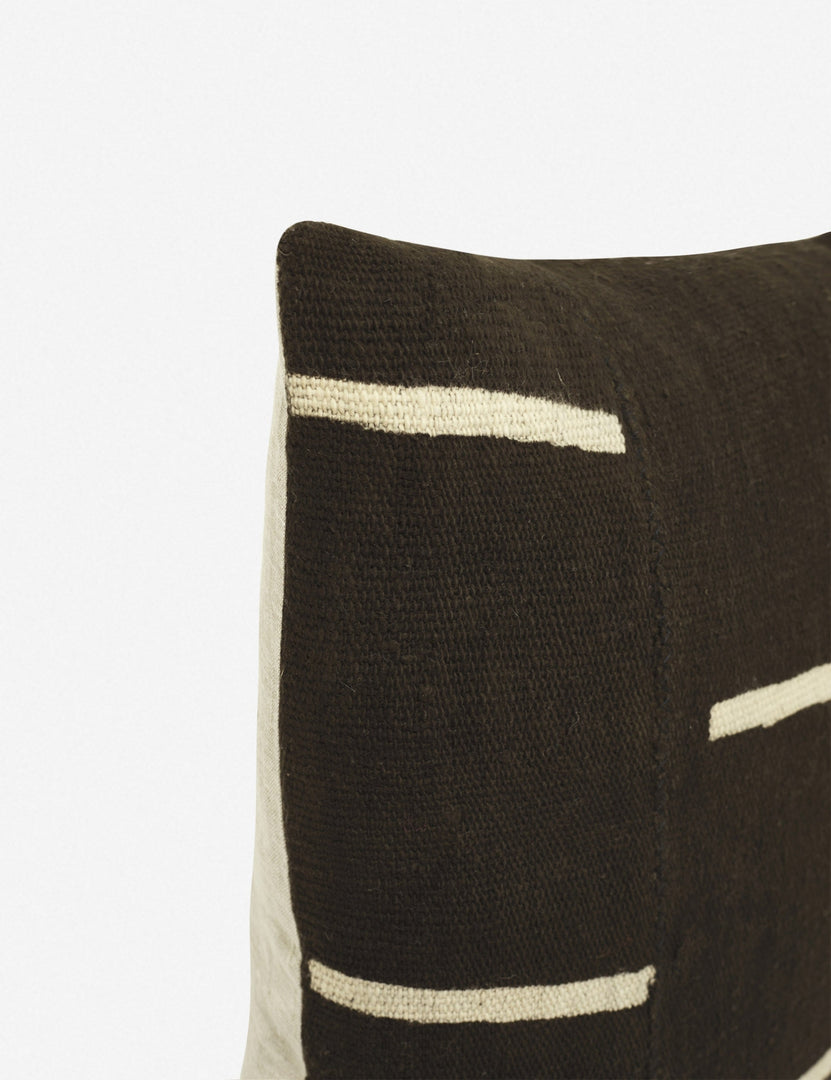 #color::black | Close-up of the corner of the Rainey mudcloth black and white pillow with a hidden zipper and gray linen back