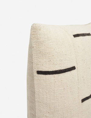 Close-up of the corner of the Rainey mudcloth ivory and black pillow with a hidden zipper and gray linen back