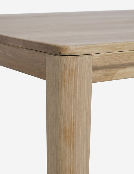 #color::oak #size::82-W | Close-up of the rounded corner of the Reese oak wood rectangular dining table.