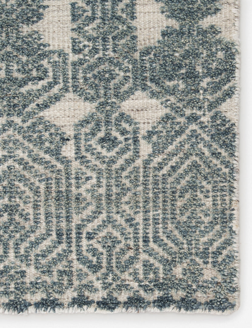 #size::5--x-8- #size::8--x-11- #color::teal-and-light-gray #size::9--x-13- | Close-up of the pattern and the corner of the Carleigh hand-knotted blue-gray patterned Rug