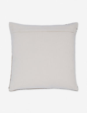 Rear view of the Rica taupe square throw pillow with blue, white, and black woven arrow-like designs