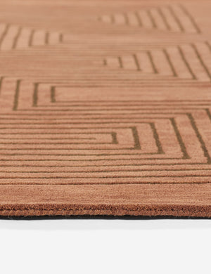 Angled close-up view of the edge and striped geometric pattern on the Simone brown tonal rug