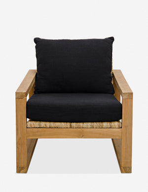 Regine wooden accent chair with black cushions and rattan detailing