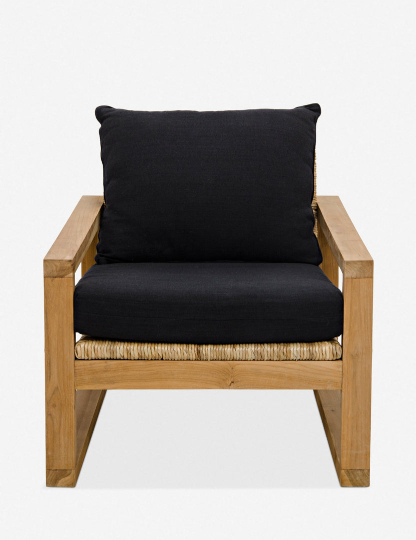 | Regine wooden accent chair with black cushions and rattan detailing