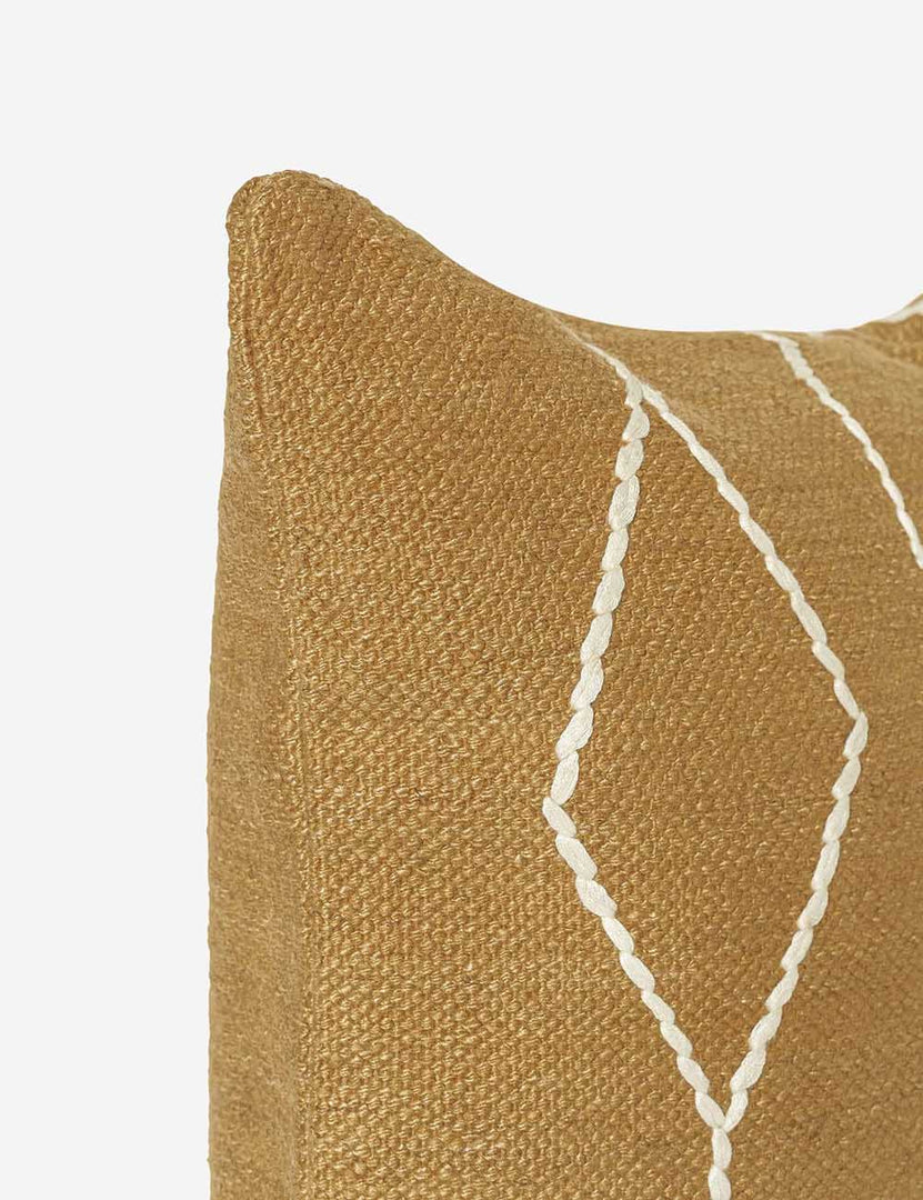 #color::ochre #style::square | Close-up of the corner of the Moroccan ochre and natural beni ourain inspired square flat weave pillow by Sarah Sherman Samuel