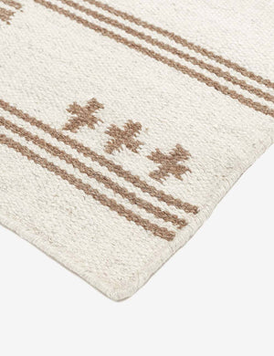 Close-up of the t-shaped patterns on the corner of the Stripe break flatweave rug by Sarah Sherman Samuel