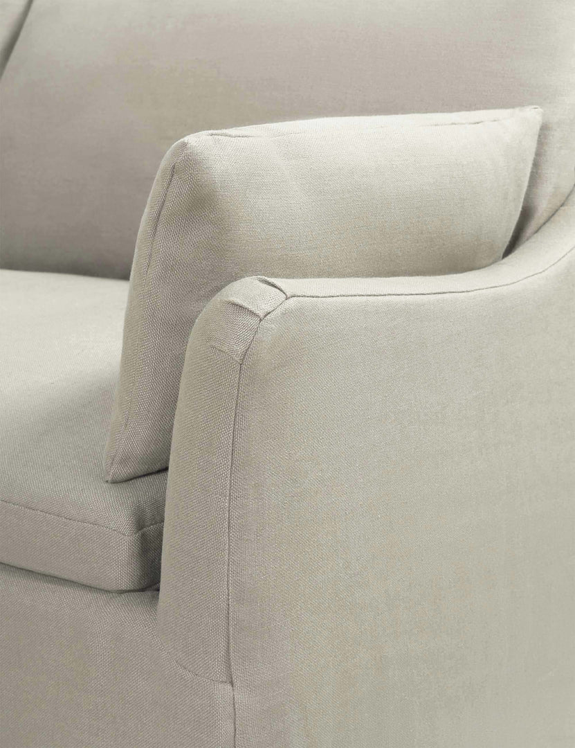 #color::natural | Close-up of the sloped-arm on the Portola Natural linen Slipcover corner sectional Sofa