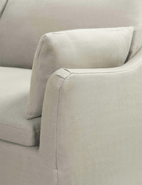 #color::natural | Close-up of the sloped-arm on the Portola Natural linen Slipcover corner sectional Sofa