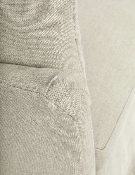 #size::72-w #size::96-w #color::natural #size::84-w | Close-up of the end of the sloped-arm on the Portola Natural linen Slipcover Sofa
