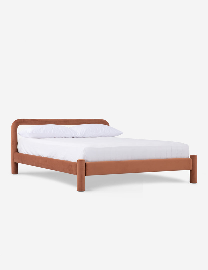 A black upholstered bed frame with rounded headboard and legs, displayed with white bedding.