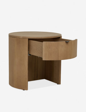 Angled left view with the drawer opened on the Kono round solid oak nightstand with one drawer