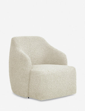 Angled view of the Tobi cream boucle swivel chair