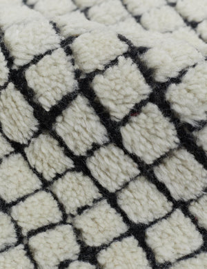Close-up of the soft pile material on the Uma black and natural checkered grid pattern rug