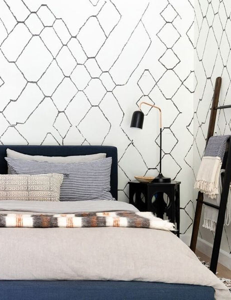 #color::smoke-gray #size::queen #size::king #size::twin #size::cal-king | The European Flax Linen smoke gray Duvet Set by Cultiver lays on a dark framed bed in a bedroom with white and black geometric patterned walls, a sculptural black nightstand, and patterned throw pillows