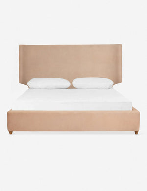 Valen buff pink upholstered platform bed with a subtle winged headboard and oak wood legs